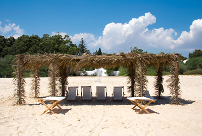 Canvas Chairs on tropical beach over blue sky